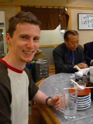 Dale with a stack of sushi plates