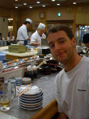 Paul with a stack of sushi plates